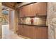 Stone accented hallway featuring wooden cabinets, granite counters, and recessed lighting at 8199 Pinnacle Peak Ave, Las Vegas, NV 89113