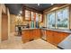 Spacious kitchen featuring wood cabinetry, stainless steel dishwasher, and breakfast nook at 8199 Pinnacle Peak Ave, Las Vegas, NV 89113