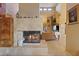 Living room with a large stone fireplace and warm, neutral tones at 8199 Pinnacle Peak Ave, Las Vegas, NV 89113