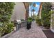 Outdoor kitchen with stainless steel grill, stone accents, and well-maintained landscaping at 8199 Pinnacle Peak Ave, Las Vegas, NV 89113