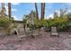 An outdoor patio with a dining table and chairs with greenery surrounding the area at 8199 Pinnacle Peak Ave, Las Vegas, NV 89113