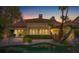 Inviting pool area with landscaping at dusk at 8199 Pinnacle Peak Ave, Las Vegas, NV 89113