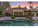 Inviting pool with spa, surrounded by lush landscaping and brick pavers at 8199 Pinnacle Peak Ave, Las Vegas, NV 89113