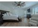 Main bedroom with king-size bed, sitting area and wood floors at 836 San Eduardo Ave, Henderson, NV 89002