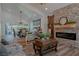 Open living room with a stone fireplace and large windows at 836 San Eduardo Ave, Henderson, NV 89002