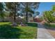 Landscaped yard with walkway and large trees at 836 San Eduardo Ave, Henderson, NV 89002