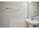 Small powder room with pedestal sink and mirror at 8672 Big Sagebrush Ave, Las Vegas, NV 89117