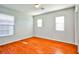 Bright bedroom with wood-look floors and two windows at 8672 Big Sagebrush Ave, Las Vegas, NV 89117