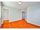 Bedroom with wood-look floors and access to another room at 8672 Big Sagebrush Ave, Las Vegas, NV 89117