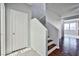 Bright entryway with wood-look floors, coat closet, and staircase at 8672 Big Sagebrush Ave, Las Vegas, NV 89117