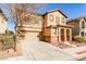 Two story home with tan exterior and a two car garage at 8672 Big Sagebrush Ave, Las Vegas, NV 89117