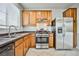 Kitchen with wood cabinets, stainless steel appliances, and tile flooring at 8672 Big Sagebrush Ave, Las Vegas, NV 89117