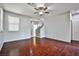 Living room with hardwood floors, ceiling fan, and staircase at 8672 Big Sagebrush Ave, Las Vegas, NV 89117