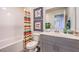 Clean bathroom with gray vanity, striped shower curtain, and colorful art at 9986 Ullom Dr # 14, Las Vegas, NV 89141