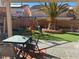 Relaxing backyard patio with seating area, lush landscaping, and play area at 11173 Varedo Ct, Las Vegas, NV 89141