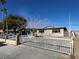 Single story home with gated driveway and landscaping at 1152 Miller Ave, Las Vegas, NV 89106