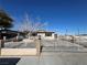 House exterior with gated entrance and mature tree at 1152 Miller Ave, Las Vegas, NV 89106