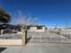 Ranch style home with gated driveway and mature trees at 1152 Miller Ave, Las Vegas, NV 89106