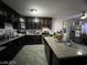 Kitchen with dark wood cabinets, granite island, and stainless steel appliances at 1152 Miller Ave, Las Vegas, NV 89106