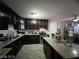 Kitchen boasts dark wood cabinets, granite island, and stainless steel appliances at 1152 Miller Ave, Las Vegas, NV 89106