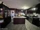 Kitchen with dark wood cabinets, granite island and stainless steel appliances at 1152 Miller Ave, Las Vegas, NV 89106