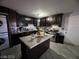 Spacious kitchen with dark cabinets, granite countertops and island at 1152 Miller Ave, Las Vegas, NV 89106