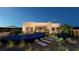 Modern home with a sleek, infinity-edge pool and relaxing lounge area at 129 Still Shores St, Henderson, NV 89011