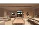 Bright dining area with a large table and access to the kitchen and patio at 129 Still Shores St, Henderson, NV 89011