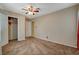 Neutral bedroom featuring a ceiling fan, neutral carpet, and a large closet at 132 Continental Ave, Henderson, NV 89015