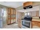 Traditional kitchen featuring light wood cabinets, stainless steel oven, and tile floors at 132 Continental Ave, Henderson, NV 89015