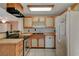 Traditional kitchen featuring tile floors, light wood cabinets, and a white refrigerator at 132 Continental Ave, Henderson, NV 89015