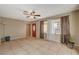 Bright living room with tile floors, large windows, and a decorative front door at 132 Continental Ave, Henderson, NV 89015