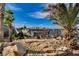 Outdoor patio with seating, desert landscaping and a wall for added privacy at 132 Continental Ave, Henderson, NV 89015