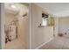 View of the water heater in the utility room with white metal rack and neutral-toned flooring at 132 Continental Ave, Henderson, NV 89015