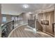 Elegant upstairs hallway with curved railing and hardwood floors at 1456 Via Merano St, Henderson, NV 89052