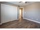 Bedroom with wood-look floors, double doors, and access to bathroom at 1559 Via Della Scala, Henderson, NV 89052