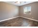 Bright bedroom featuring wood-look floors and a ceiling fan at 1559 Via Della Scala, Henderson, NV 89052