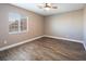 Bright bedroom with wood-look floors and window with blinds at 1559 Via Della Scala, Henderson, NV 89052