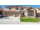 Two-story house with a three-car garage and landscaped lawn at 1559 Via Della Scala, Henderson, NV 89052