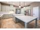 Modern kitchen with light cabinets, quartz countertops, and stainless steel appliances at 1559 Via Della Scala, Henderson, NV 89052