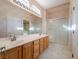 Bathroom boasts double sinks, wood cabinets, and a shower at 1803 Eagle Village Ave, Henderson, NV 89012