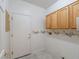 Laundry room with built-in cabinets and a door to the outside at 1803 Eagle Village Ave, Henderson, NV 89012