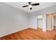 Bedroom with wood floors, ceiling fan, and walk-in closet at 1836 La Calera Ave, North Las Vegas, NV 89084
