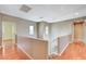 Upstairs hallway with wood floors and access to bedrooms at 1836 La Calera Ave, North Las Vegas, NV 89084