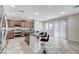 Open kitchen with island, stainless steel appliances, and dark wood cabinets at 1836 La Calera Ave, North Las Vegas, NV 89084