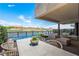 Covered patio with lake view, seating area, and dining table at 20 Lakefront Dr, Henderson, NV 89011