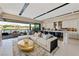 Spacious great room features a kitchen, living area, and access to a patio overlooking a lake at 20 Lakefront Dr, Henderson, NV 89011