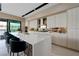Modern kitchen boasts a large island, white cabinetry, and stainless steel appliances at 20 Lakefront Dr, Henderson, NV 89011