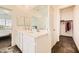 Double vanity bathroom with white cabinets and a walk-in closet at 20 Barbara Ln # 35, Las Vegas, NV 89183