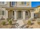 Townhome entrance with covered porch and landscaping at 20 Barbara Ln # 35, Las Vegas, NV 89183